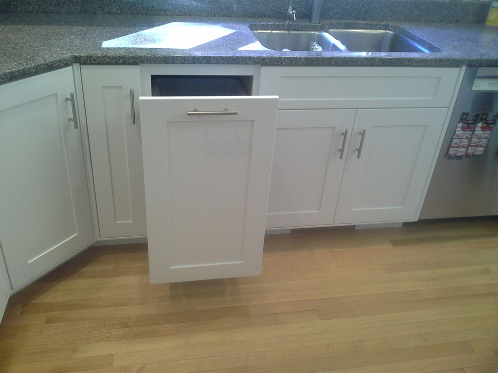 Large transitional light wood floor eat-in kitchen photo in Boston with recessed-panel cabinets, white cabinets, granite countertops, multicolored backsplash, glass tile backsplash and stainless steel appliances