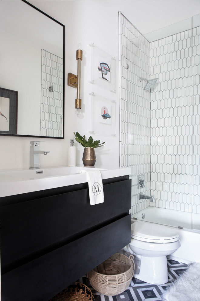 Inspiration for a mid-sized transitional 3/4 bathroom in Other with flat-panel cabinets, black cabinets, a drop-in tub, a shower/bathtub combo, white tile, mosaic tile, white walls, a console sink, multi-coloured floor and marble benchtops.