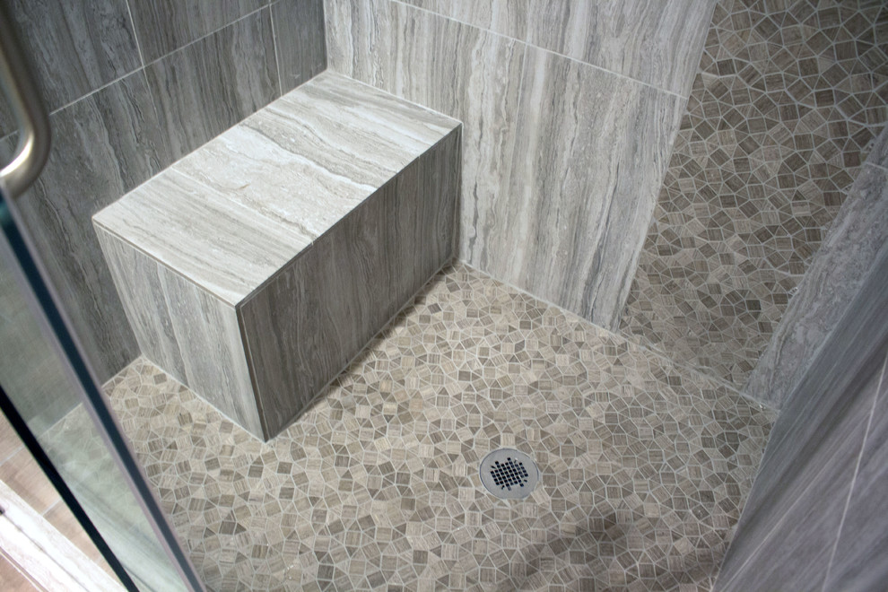 Inspiration for a mid-sized contemporary bathroom in Houston with recessed-panel cabinets, white cabinets, an alcove shower, beige tile, gray tile, mosaic tile, beige walls, porcelain floors, an undermount sink, quartzite benchtops, beige floor, a sliding shower screen and white benchtops.