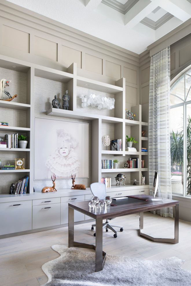 Inspiration for a large transitional study room in Miami with grey walls, a freestanding desk, light hardwood floors and beige floor.
