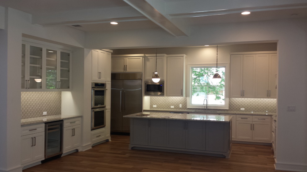 Open concept kitchen - large transitional l-shaped light wood floor open concept kitchen idea in Austin with an island, an undermount sink, shaker cabinets, white cabinets, granite countertops, glass sheet backsplash and stainless steel appliances