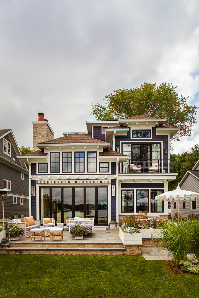 Inspiration for a large beach style three-storey blue house exterior in Detroit.