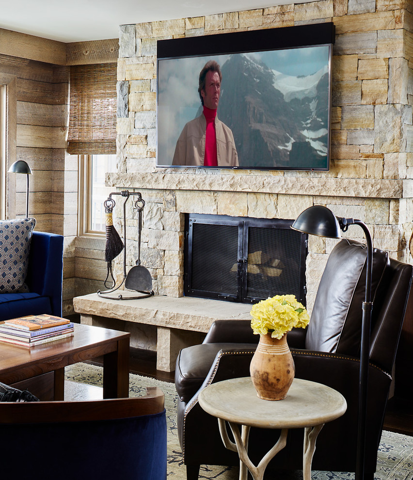 This is an example of a country family room in Denver with a wall-mounted tv.