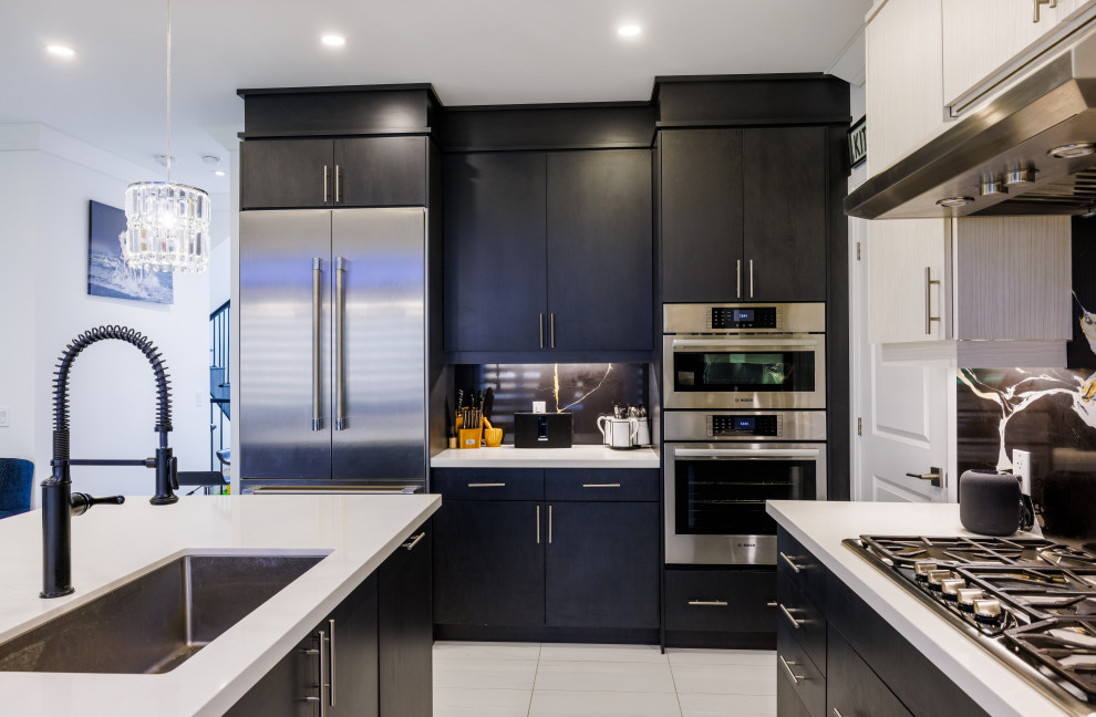 Inspiration for a modern eat-in kitchen in Other with an undermount sink, flat-panel cabinets, black cabinets, black splashback, granite splashback, stainless steel appliances, porcelain floors, with island, white floor and white benchtop.