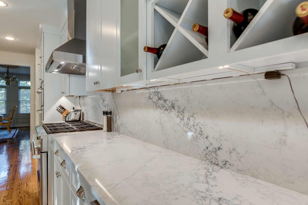 Inspiration for a small contemporary u-shaped kitchen in DC Metro with an undermount sink, recessed-panel cabinets, white cabinets, quartzite benchtops, stainless steel appliances and a peninsula.
