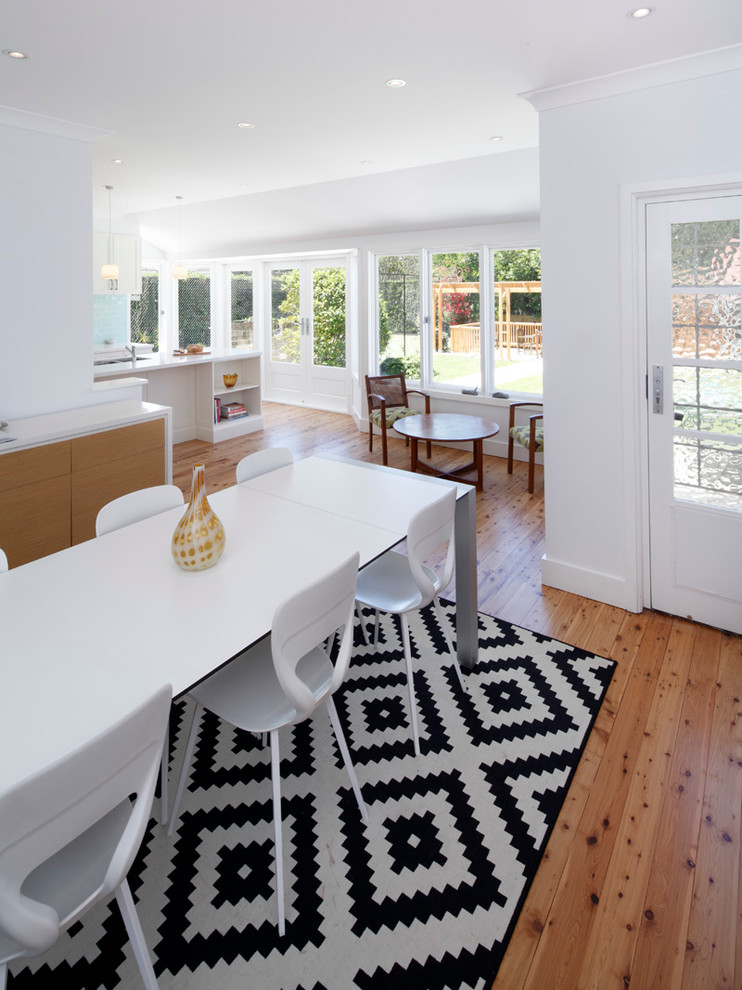 Large transitional l-shaped eat-in kitchen in Sydney with an undermount sink, shaker cabinets, white cabinets, quartz benchtops, blue splashback, ceramic splashback, stainless steel appliances, bamboo floors and with island.