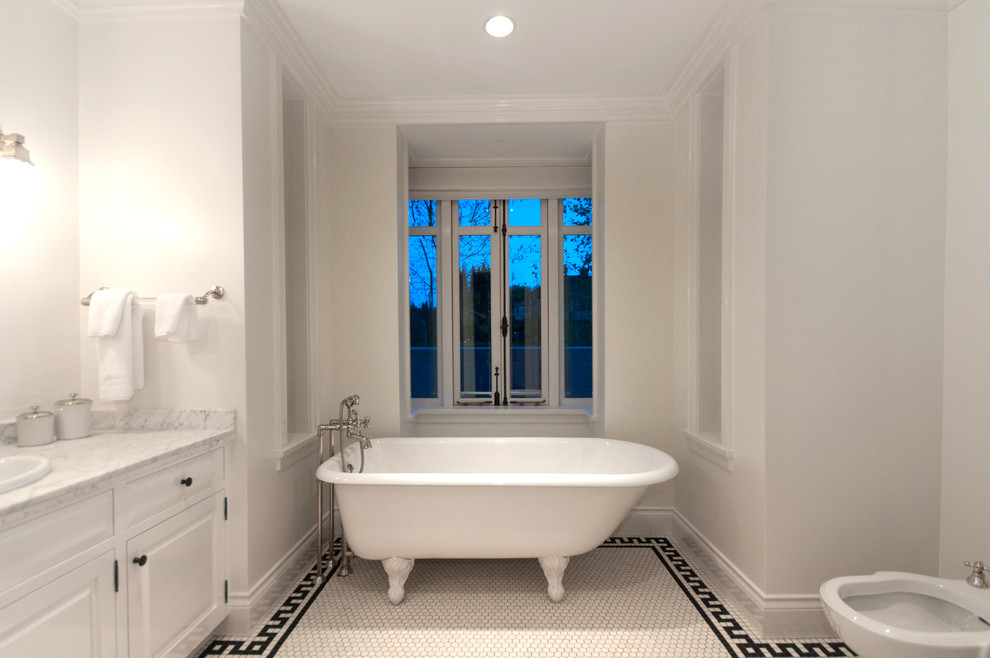 Inspiration for a traditional bathroom in Vancouver with a drop-in sink, raised-panel cabinets, white cabinets, a claw-foot tub and mosaic tile floors.