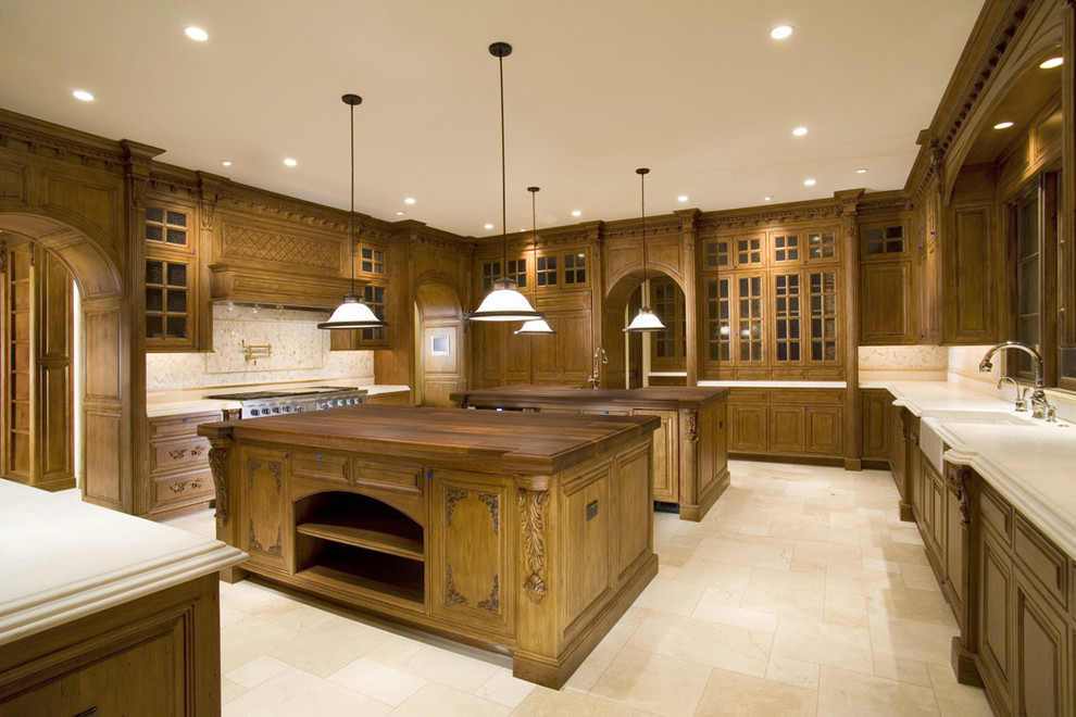 Photo of a traditional kitchen in Phoenix with glass-front cabinets and a farmhouse sink.