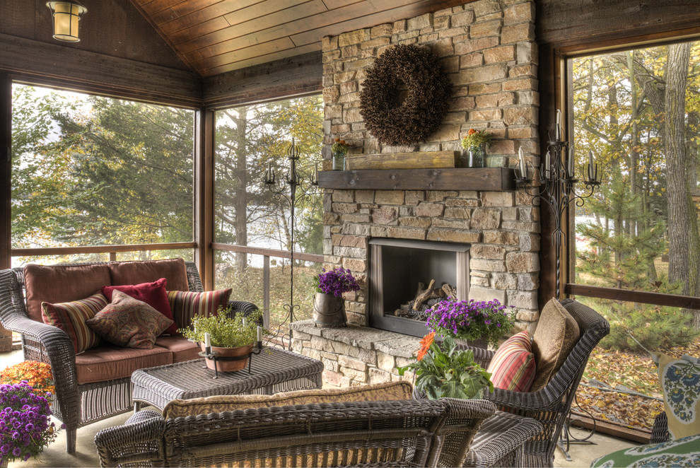 Inspiration for a large country backyard screened-in verandah in Minneapolis with a roof extension.
