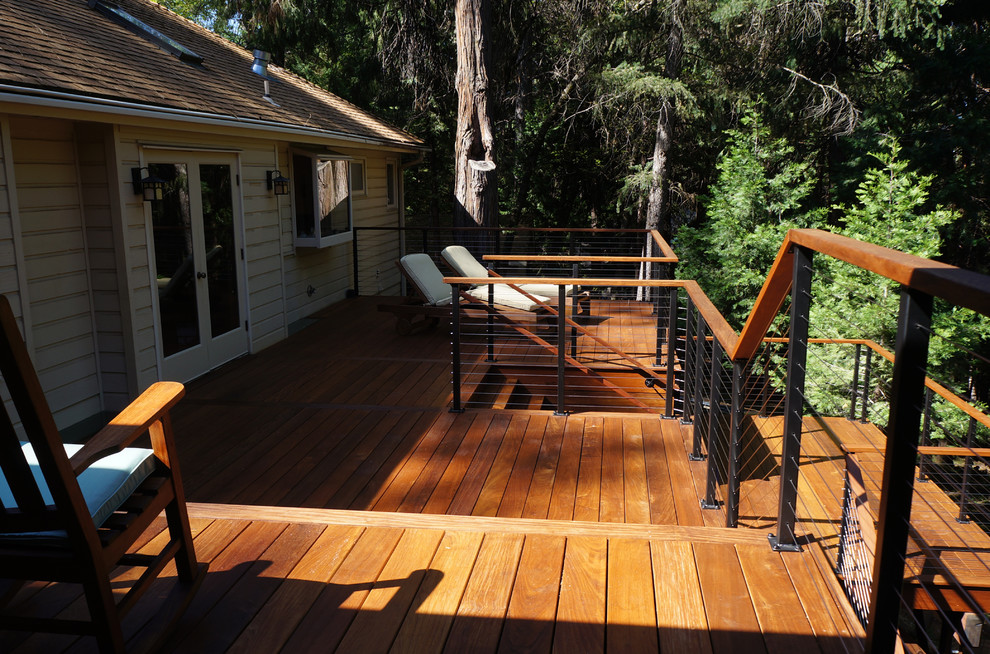 Design ideas for a large modern backyard deck in Sacramento with no cover.