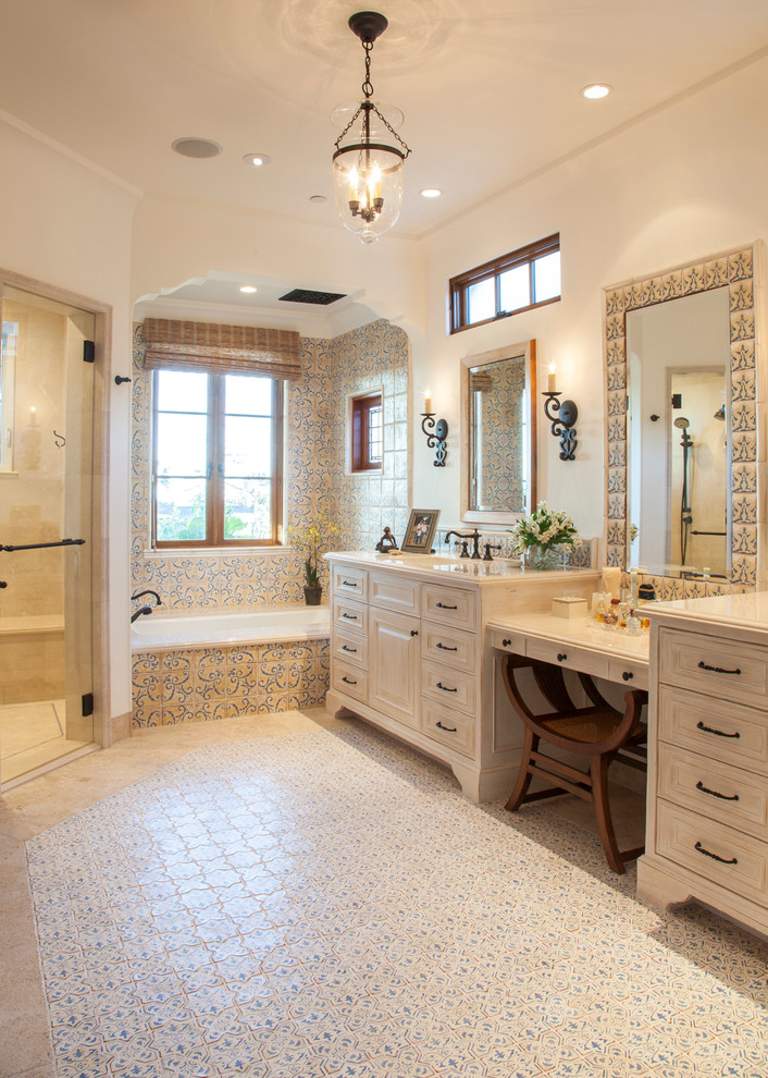 Inspiration for a mid-sized mediterranean master bathroom in San Diego with beige cabinets, an alcove tub, multi-coloured tile, white walls, a curbless shower, ceramic tile, travertine floors, an undermount sink, engineered quartz benchtops, a hinged shower door and recessed-panel cabinets.