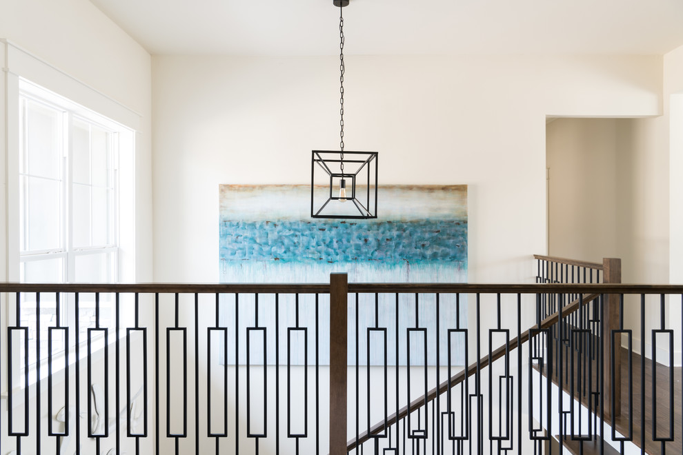 This is an example of a mid-sized beach style foyer with white walls, medium hardwood floors, a single front door, a medium wood front door and brown floor.