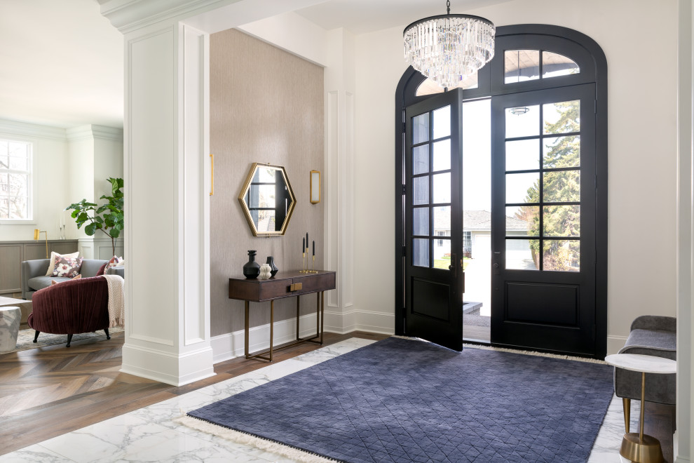 This is an example of an expansive transitional front door in Calgary with white walls, marble floors, a double front door, a black front door, white floor and wallpaper.