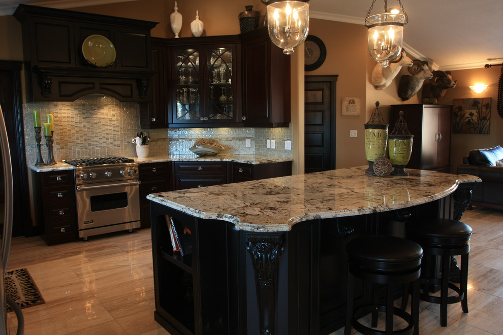 Photo of a mid-sized transitional l-shaped eat-in kitchen in Edmonton with an undermount sink, raised-panel cabinets, granite benchtops, metallic splashback, stainless steel appliances, black cabinets, metal splashback, porcelain floors and with island.