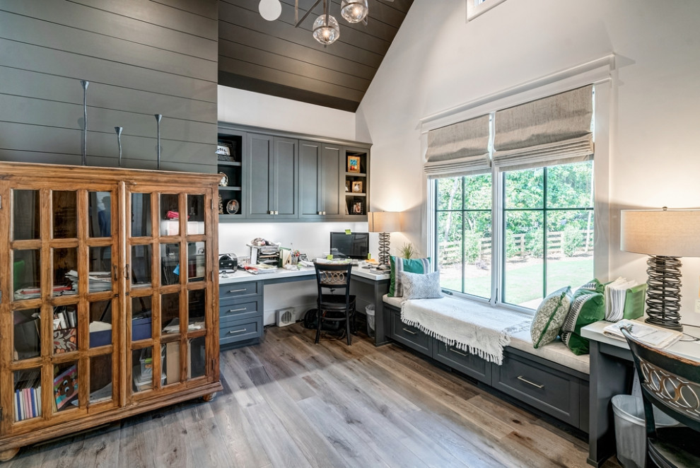Modern home office in Atlanta with white walls, a built-in desk, vaulted and planked wall panelling.