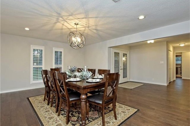 Design ideas for a large transitional dining room in Austin with grey walls and medium hardwood floors.