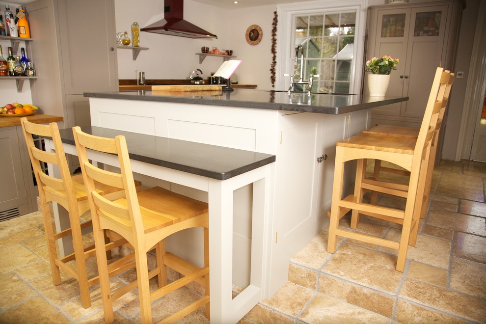 Design ideas for a mid-sized country eat-in kitchen in Surrey with an undermount sink, shaker cabinets, granite benchtops, limestone floors and with island.