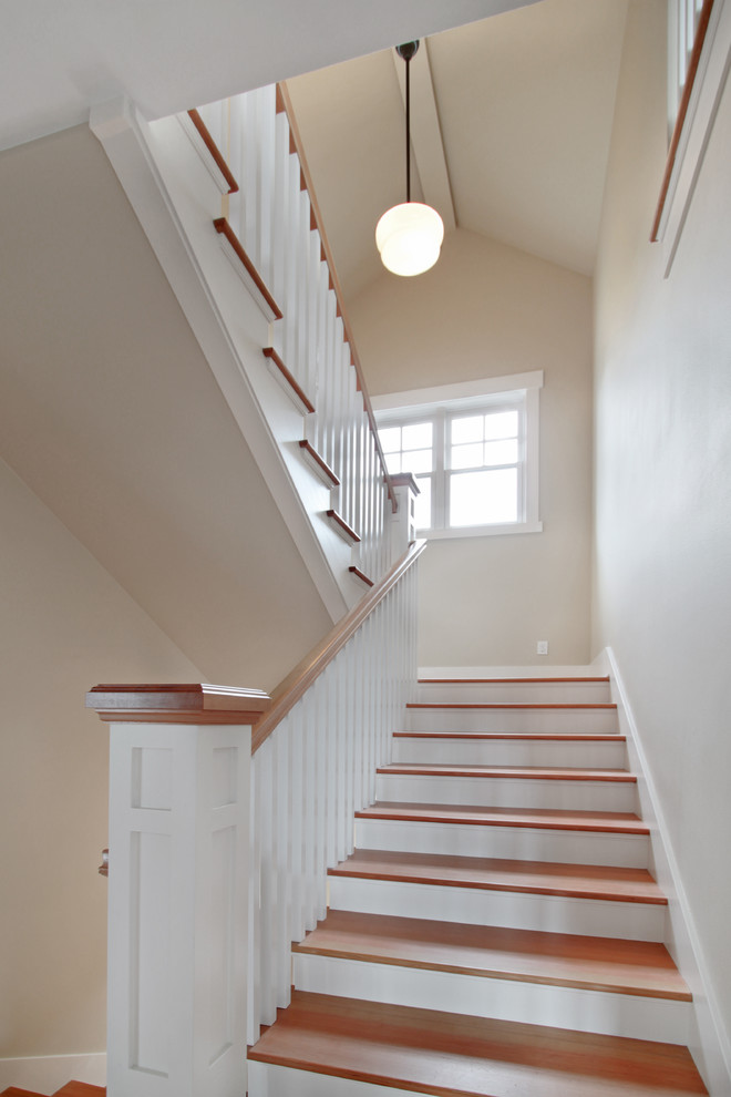 Inspiration for a mid-sized arts and crafts wood u-shaped staircase in Seattle with wood risers and wood railing.