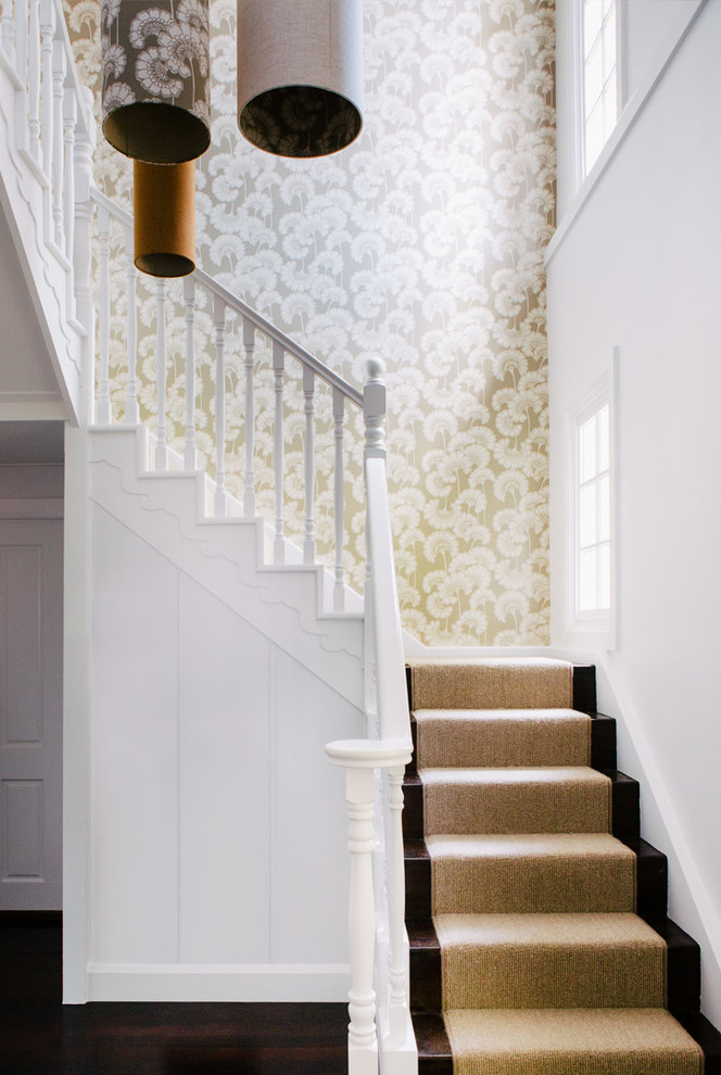 This is an example of a transitional wood u-shaped staircase in Sydney with wood railing and wood risers.
