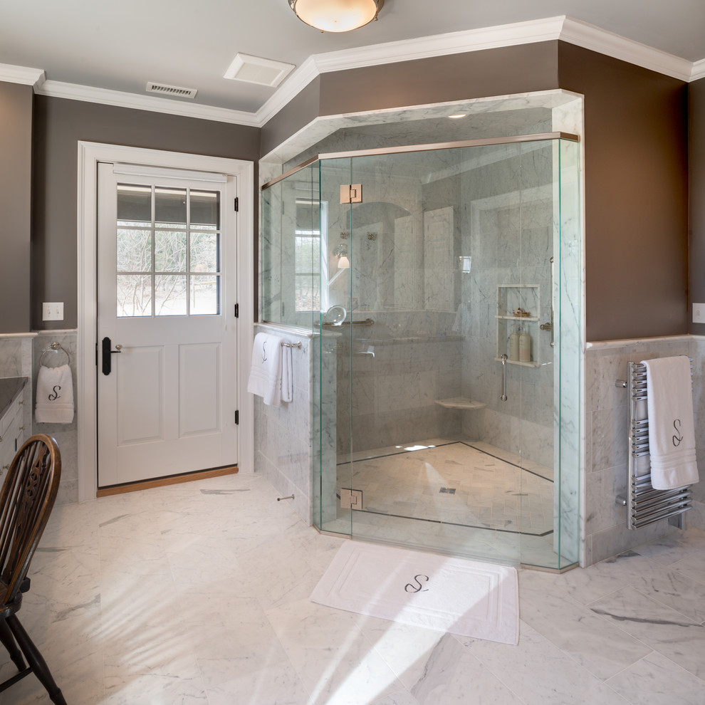 Design ideas for a traditional master bathroom in Philadelphia with an undermount sink, raised-panel cabinets, white cabinets, granite benchtops, white tile, stone tile, grey walls, marble floors and a corner shower.