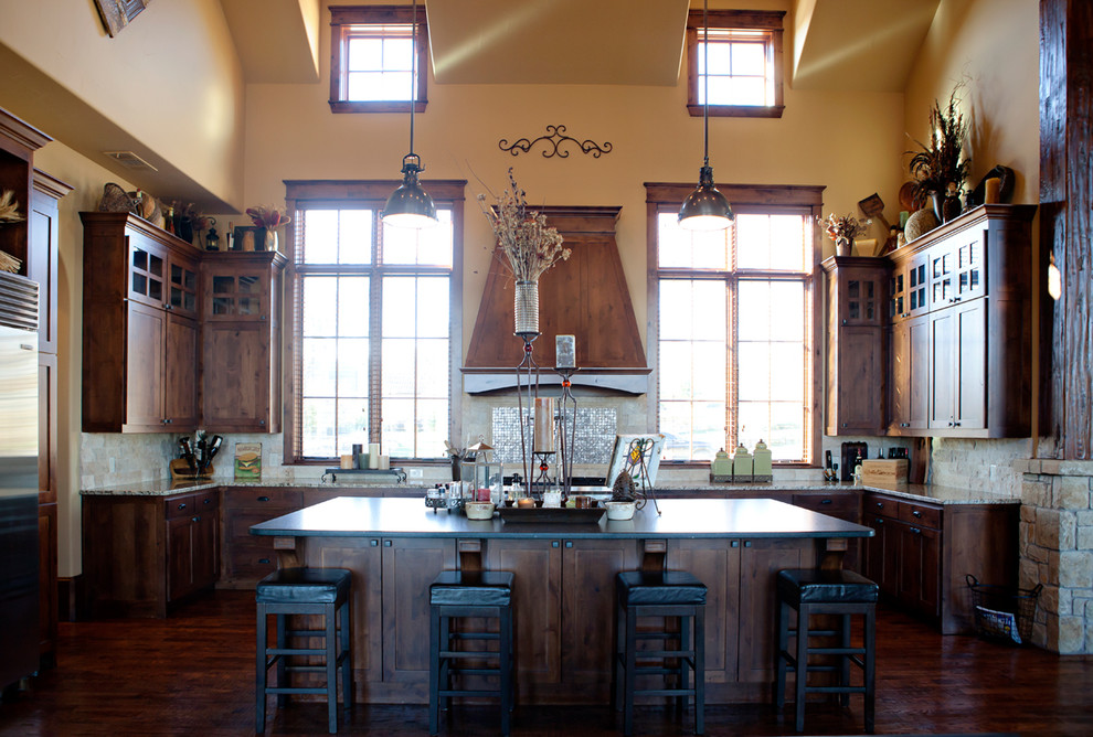 Eat-in kitchen - rustic u-shaped dark wood floor eat-in kitchen idea in Dallas with medium tone wood cabinets, granite countertops, stone tile backsplash, stainless steel appliances, an island and shaker cabinets