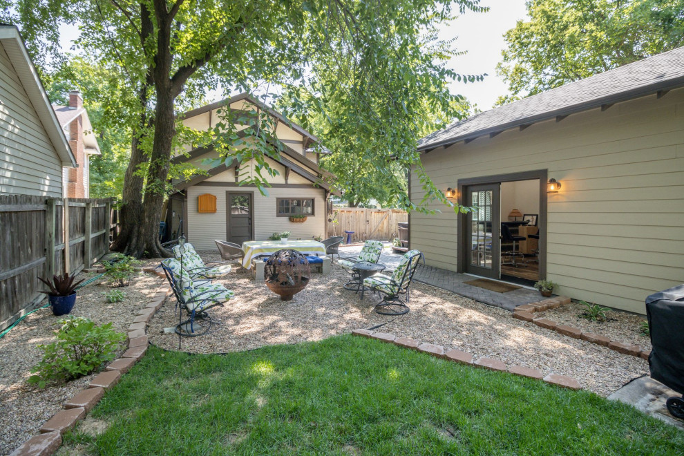 Mid-sized eclectic backyard patio in Wichita with gravel and no cover.