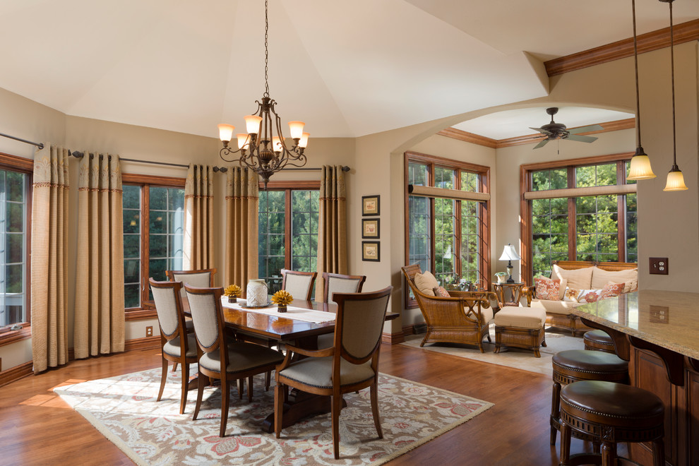 Photo of a traditional dining room in Milwaukee with beige walls, dark hardwood floors and brown floor.