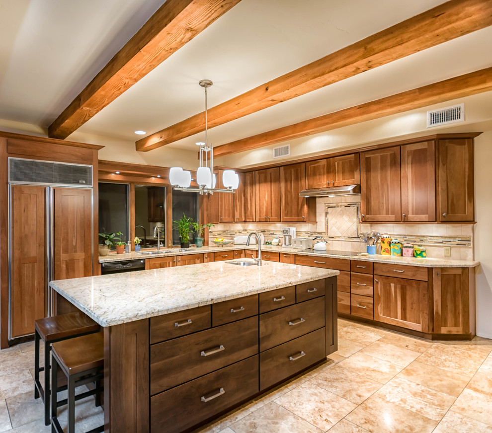 Photo of a large transitional u-shaped eat-in kitchen in Phoenix with an undermount sink, shaker cabinets, medium wood cabinets, granite benchtops, beige splashback, stone tile splashback, panelled appliances, travertine floors and with island.
