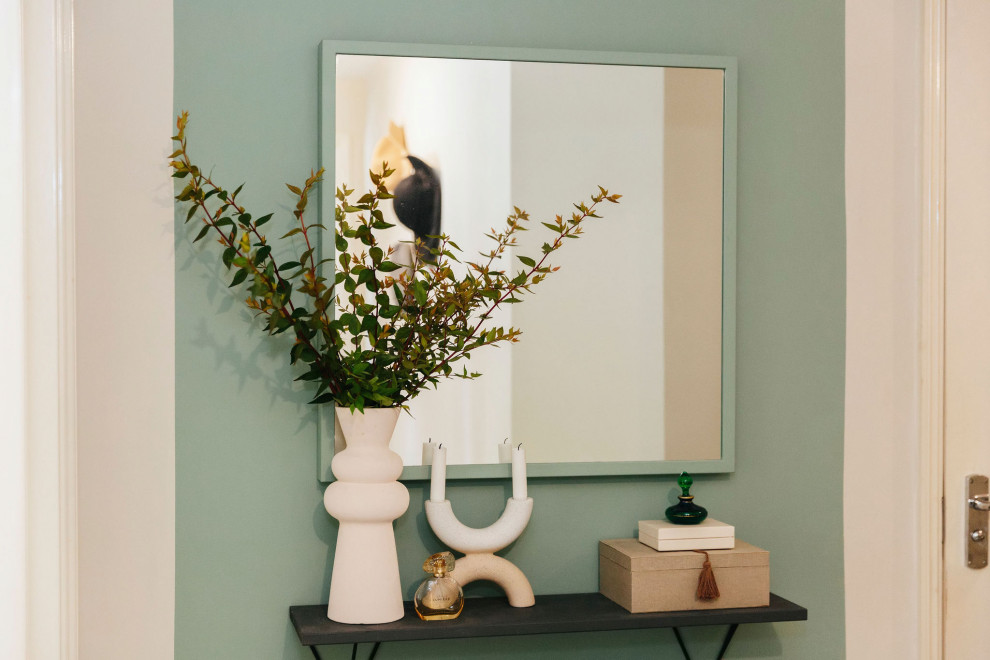 Inspiration for a small contemporary hallway in Hampshire with green walls, light hardwood floors and beige floor.