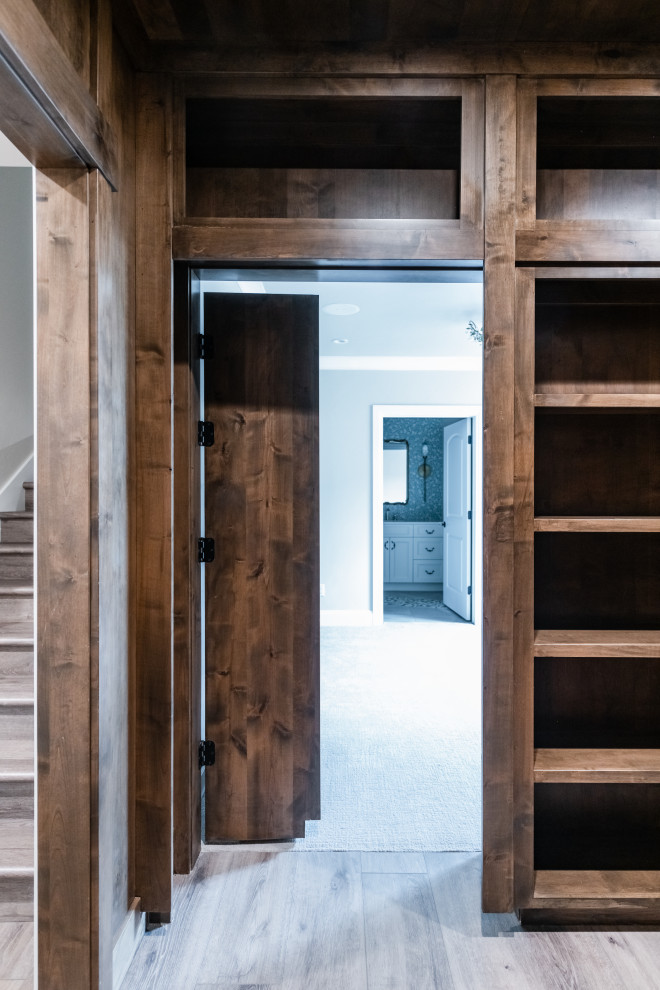 This is an example of a mid-sized transitional hallway in Salt Lake City with brown walls, vinyl floors, brown floor and wood walls.