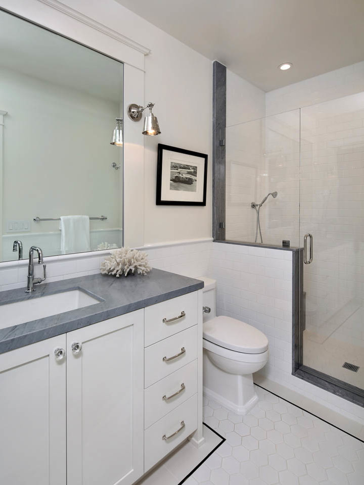 This is an example of a mid-sized country bathroom in San Francisco with shaker cabinets, white cabinets, an alcove shower, white tile, subway tile, an undermount sink, marble benchtops, a two-piece toilet, white walls, ceramic floors, white floor and a hinged shower door.