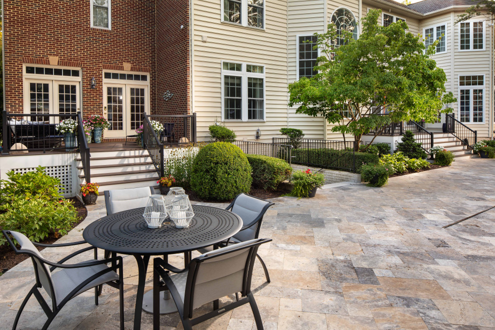 Inspiration for a transitional patio in DC Metro with natural stone pavers.