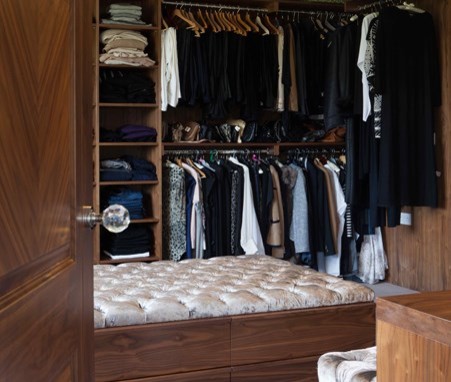 Design ideas for a contemporary gender neutral walk-in wardrobe in London with open cabinets and dark wood cabinets.