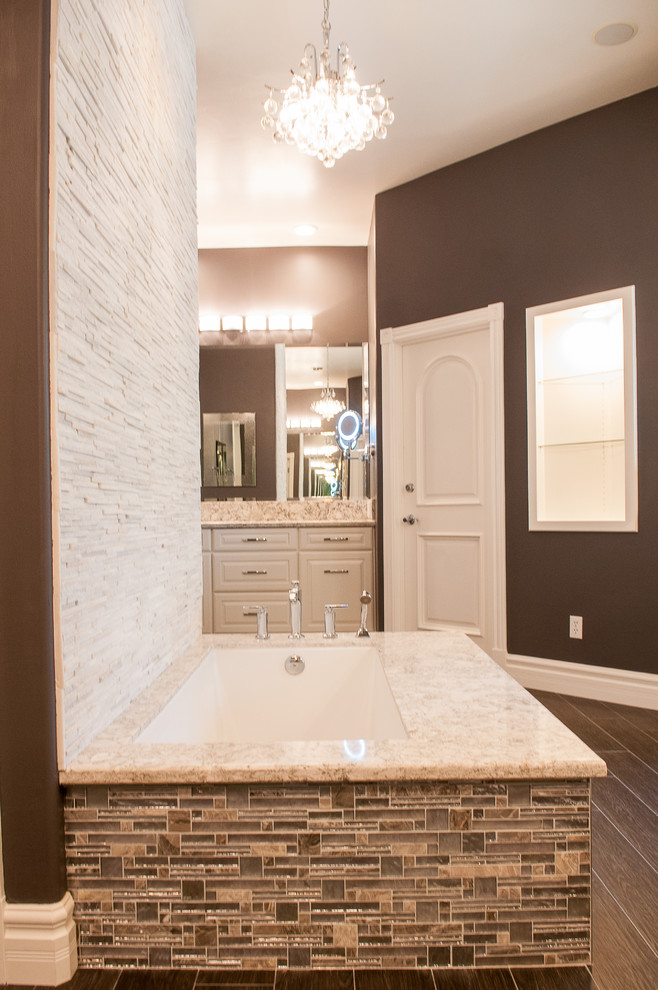Mid-sized transitional master beige tile, brown tile and mosaic tile dark wood floor and brown floor corner shower photo with raised-panel cabinets, white cabinets, an undermount tub, brown walls, a vessel sink, granite countertops and a hinged shower door