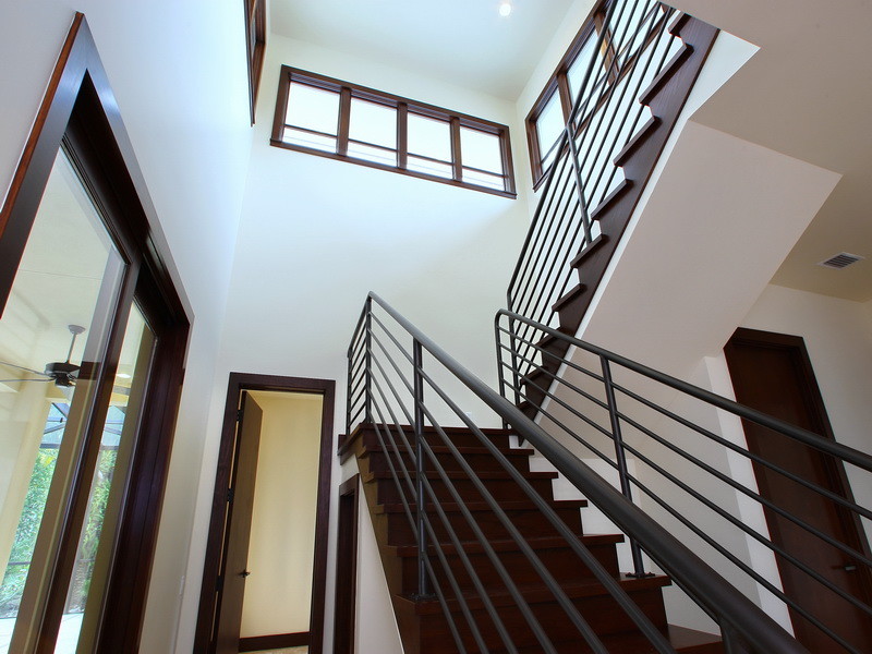 Photo of a contemporary wood u-shaped staircase in Tampa with wood risers.