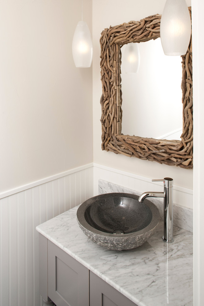 This is an example of a small beach style powder room in Denver with a vessel sink, shaker cabinets, grey cabinets, marble benchtops, gray tile and grey walls.