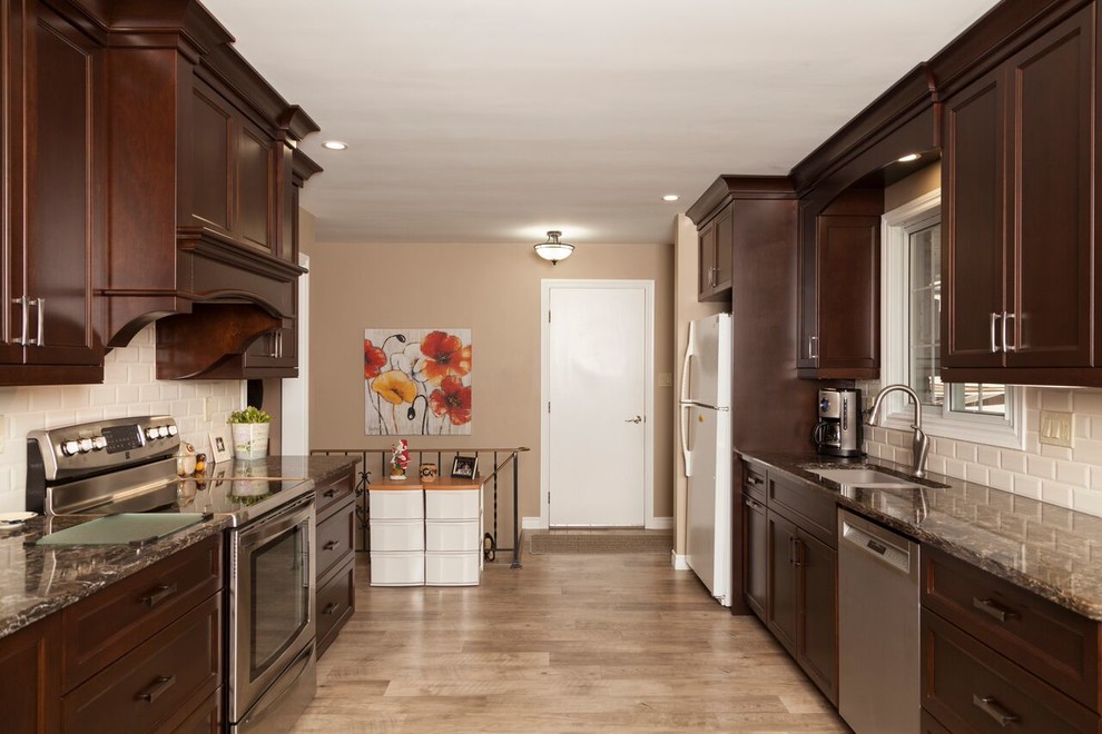 Transitional kitchen photo in Toronto with shaker cabinets, dark wood cabinets, granite countertops, white backsplash, subway tile backsplash and stainless steel appliances