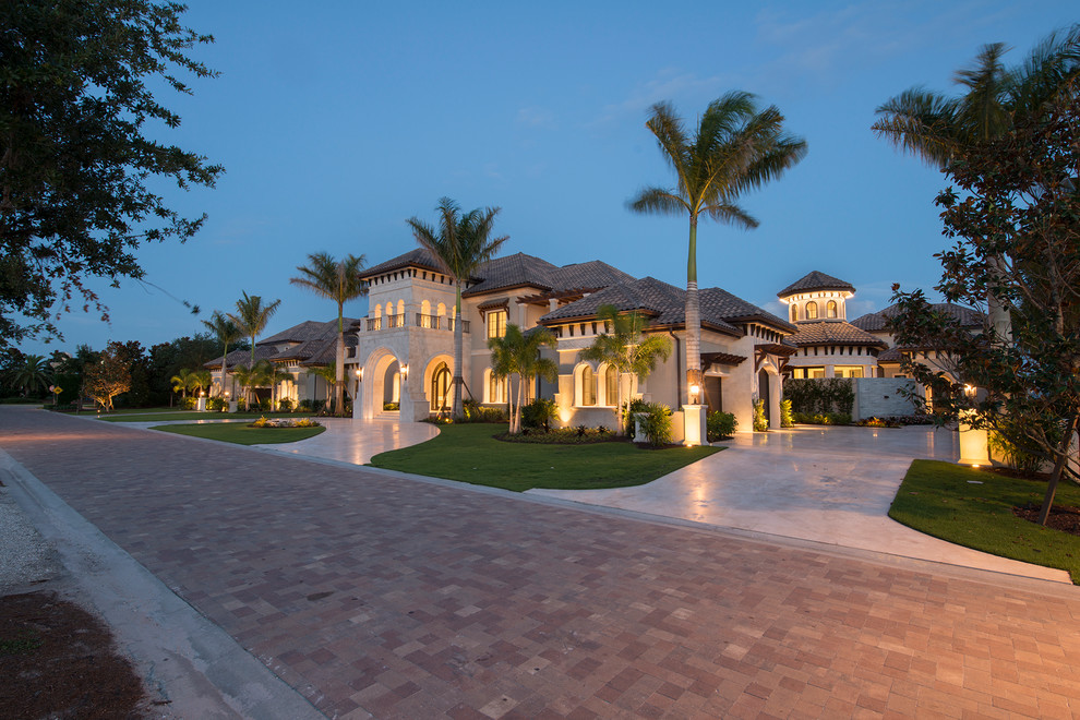 Inspiration for a transitional two-story stucco exterior home remodel in Miami