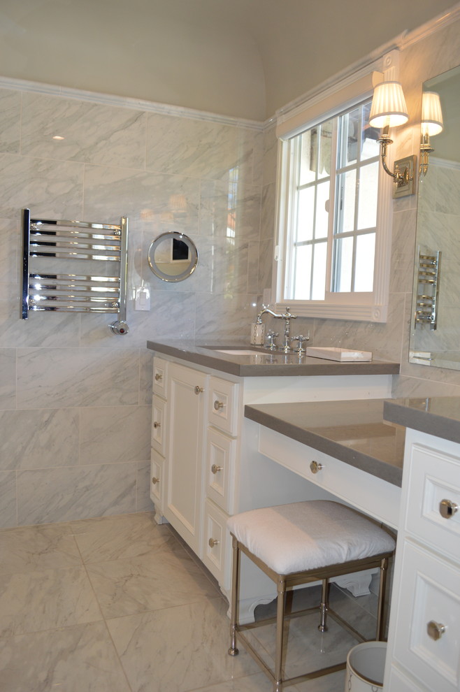 Inspiration for a mid-sized transitional master bathroom in Los Angeles with recessed-panel cabinets, white cabinets, a freestanding tub, a corner shower, a bidet, gray tile, porcelain tile, grey walls, porcelain floors, an undermount sink and quartzite benchtops.