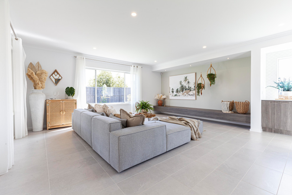 Design ideas for a large tropical open concept family room in Melbourne with grey walls, ceramic floors and grey floor.