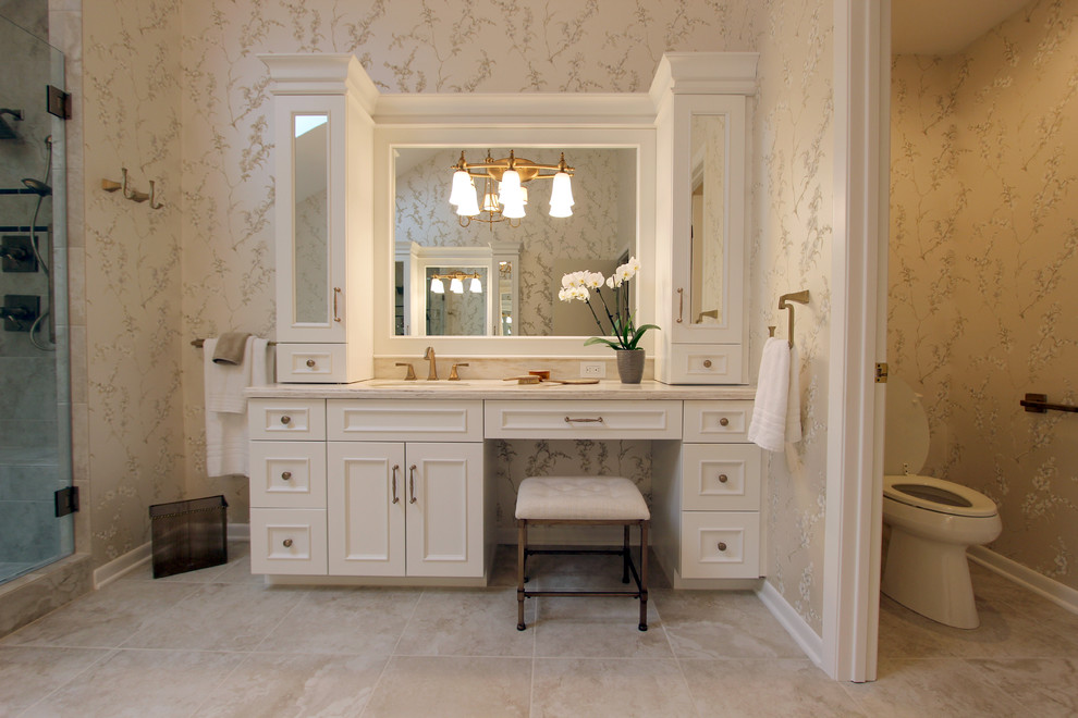 Inspiration for a large traditional master bathroom in Cleveland with an undermount sink, raised-panel cabinets, white cabinets, a corner tub, a corner shower, beige tile, porcelain tile, beige walls and porcelain floors.