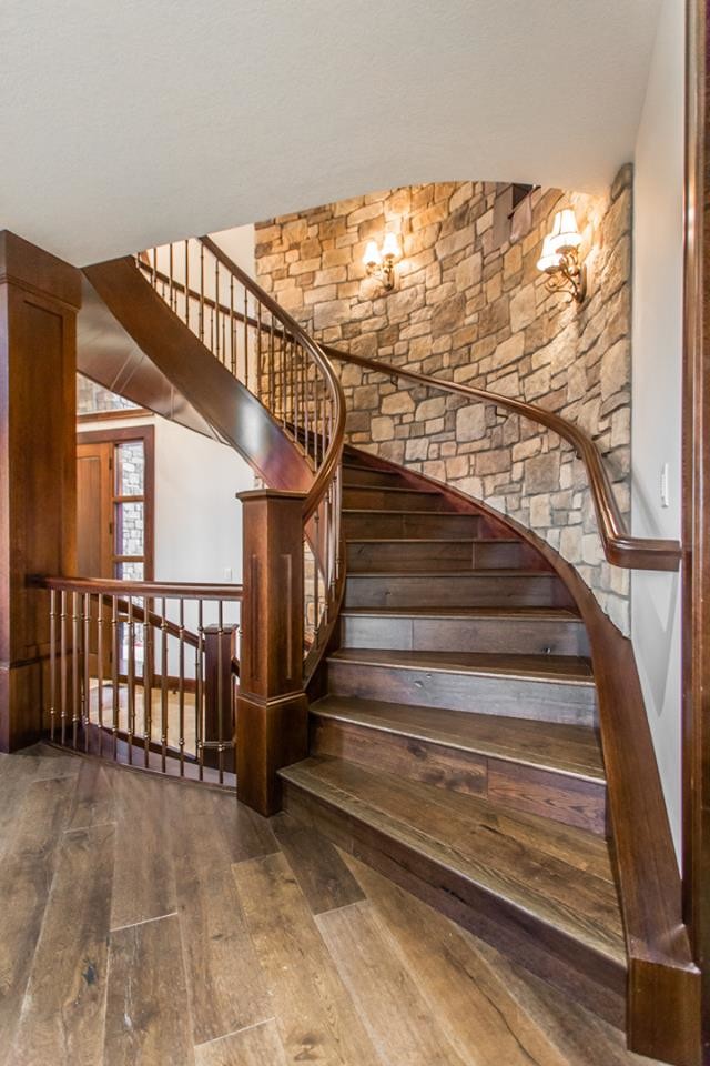 Inspiration for a country wood curved staircase in Other with wood risers and wood railing.