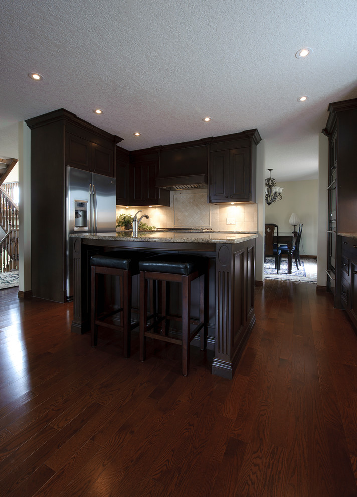 Example of a transitional kitchen design in Calgary