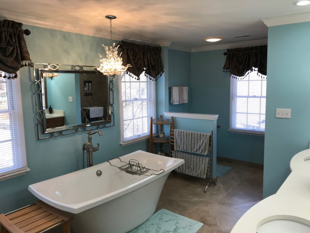 This is an example of a large transitional master bathroom in Chicago with medium wood cabinets, a freestanding tub, an alcove shower, beige tile, porcelain tile, blue walls, porcelain floors, an undermount sink, engineered quartz benchtops, beige floor, an open shower, white benchtops, a niche, a double vanity and a built-in vanity.