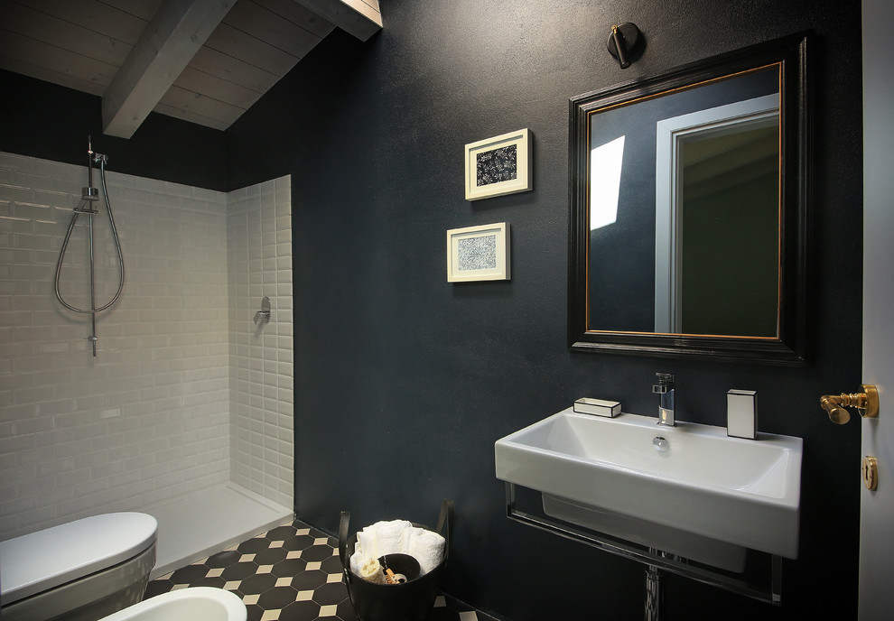 Inspiration for a mid-sized country 3/4 bathroom in Milan with an open shower, a wall-mount toilet, multi-coloured tile, black walls, ceramic floors, a wall-mount sink, multi-coloured floor and an open shower.