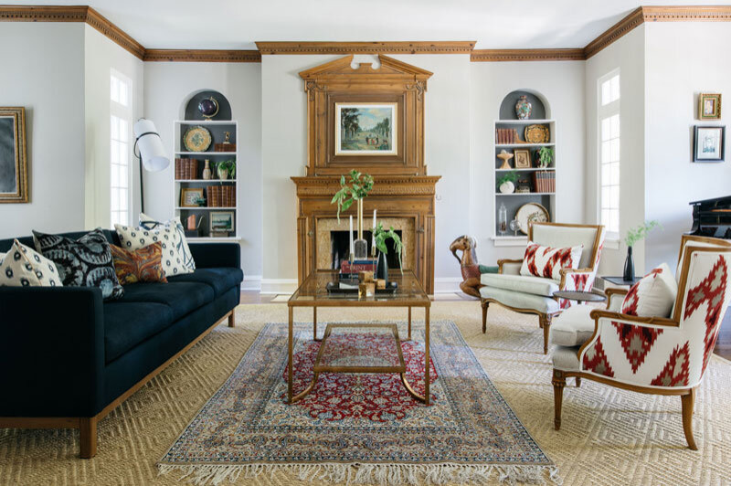 Photo of a mid-sized transitional formal enclosed living room in Chicago with beige walls, medium hardwood floors, a standard fireplace, a wood fireplace surround, no tv and brown floor.