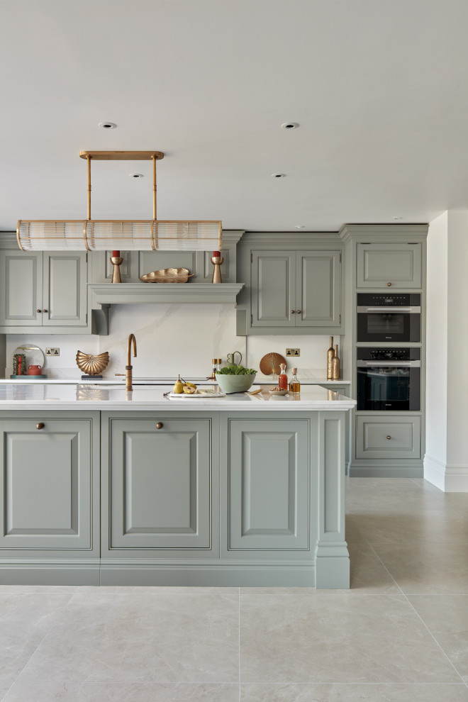 This is an example of a mid-sized traditional galley separate kitchen in Other with shaker cabinets, green cabinets, quartzite benchtops, white splashback, engineered quartz splashback, black appliances, with island and white benchtop.