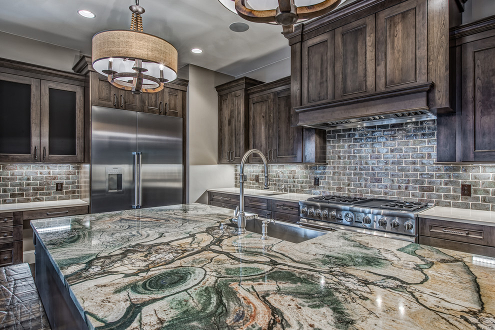 Inspiration for a large transitional u-shaped dark wood floor open concept kitchen remodel in Denver with a farmhouse sink, raised-panel cabinets, dark wood cabinets, granite countertops, gray backsplash, subway tile backsplash, stainless steel appliances and an island