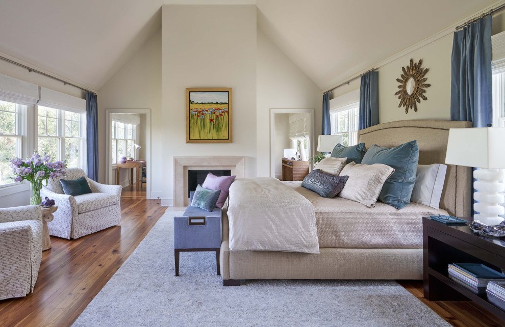 Transitional medium tone wood floor, brown floor and vaulted ceiling bedroom photo in Charlotte with white walls, a standard fireplace and a stone fireplace
