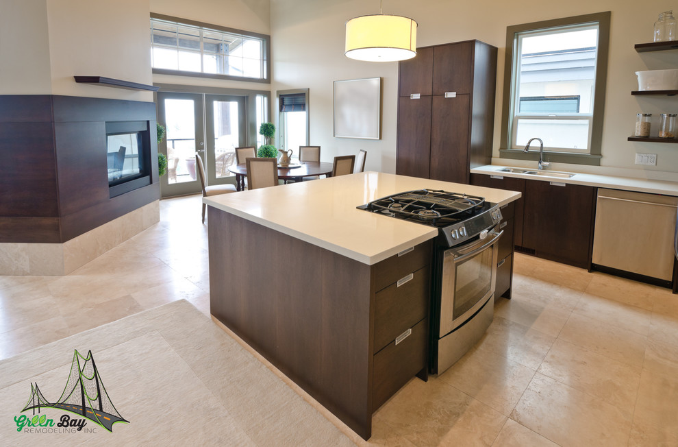 This is an example of a large contemporary l-shaped eat-in kitchen in San Francisco with flat-panel cabinets, brown cabinets, quartz benchtops, travertine floors, with island, a double-bowl sink and stainless steel appliances.